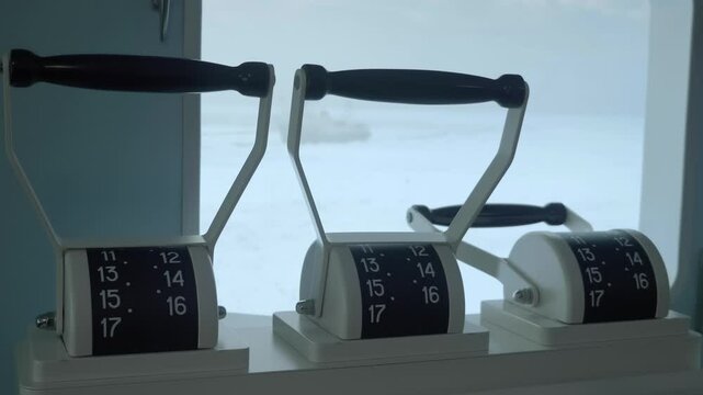 The wheelhouse of a nuclear icebreaker in the Arctic, with command levers on the engine room telegraph, from where commands are given to control the ship's speed and direction. Shot in motion