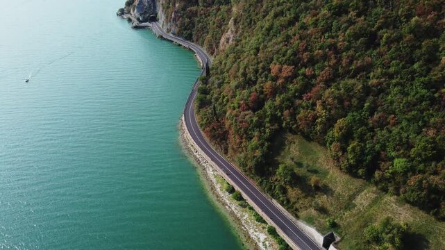 drone fly above Iseo lake, also known as Sebino, is the fourth largest lake in Lombardy revealing scenic panoramic road