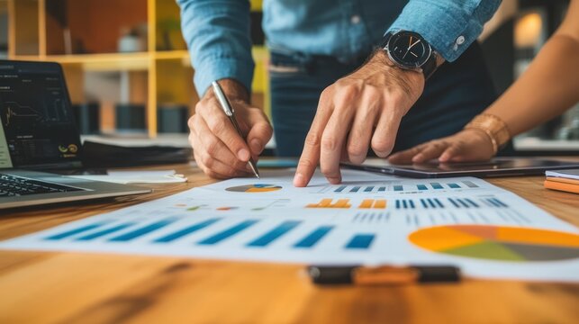 A startup consultant helping entrepreneurs design a business plan in a co-working space with modern technology