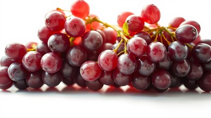 Fototapeta premium A vibrant cluster of plump, ruby-red grapes, glistening with dew, displayed against a stark white backdrop, highlighting their succulent nature.