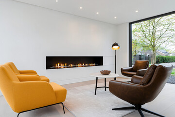 a minimalist living space with gas fireplace with leather armchairs