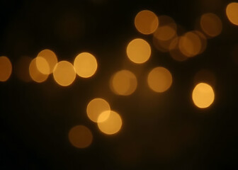 Fototapeta premium Glittery vintage lights in black and gold colors create a blurred effect on the background.