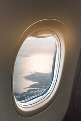 Serene Aerial View Through Airplane Window Showcasing Landscape and Clouds