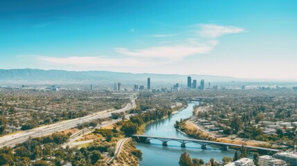 Fototapeta premium Aerial view of the river in Los Angeles with industrial areas on one side and residential neighborhoods on the other,