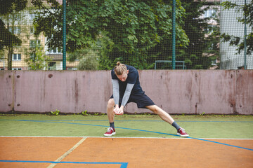 Obraz premium Volleyball player performing a digging on a hard court, focusing intently on the ball during an intense game. The action showcases skill, concentration, and athleticism