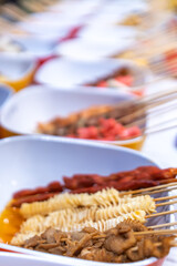Colorful Array of Skewered Street Food Dishes Ready for Grilling
