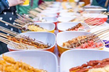 Vibrant Street Food Market Featuring Skewered Delicacies on Display