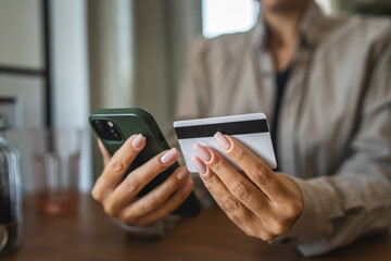 Adult woman use smart phone for online shopping transaction safely