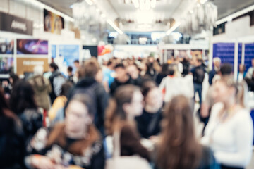Abstract blurred people at exhibition hall of expo event trade show. Business convention show or...