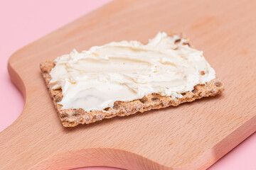 Whole Grain Crispbread with Cream Cheese on Wooden Cutting Board. Quick and Healthy Sandwiches. Healthy Dietary Snack