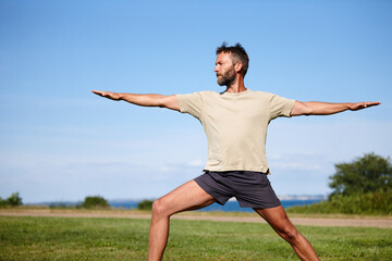 Nature, man and stretching on grass with yoga for exercise, balance or mobility at park. Pilates, mature yogi and warrior pose on lawn for workout, holistic wellness or posture with fitness on mockup