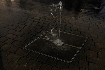 Water fountain splashing on the ground in front of a modern building Central Business District Prague Masaryk 
