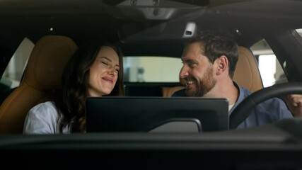 Happy couple celebrate buying new car sitting inside salon achieve gesture Caucasian family boyfriend girlfriend wife husband male female woman man girl guy rejoice buy auto automobile rent test drive