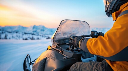 Person riding snowmobile on snowy terrain during sunset, showcasing winter adventure and excitement.