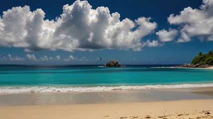 Obraz premium A picturesque view of a tropical beach with crystal clear turquoise waters, white sand, and a small island in the distance. The sky is bright blue with fluffy white clouds.