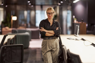 A confident businesswoman thriving in a modern office, exuding professionalism and determination