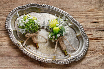 Wedding boutonniere with yellow chrysanthemum and gypsophila paniculata