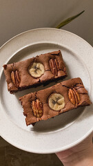 banana brownies topped with banana and pecans