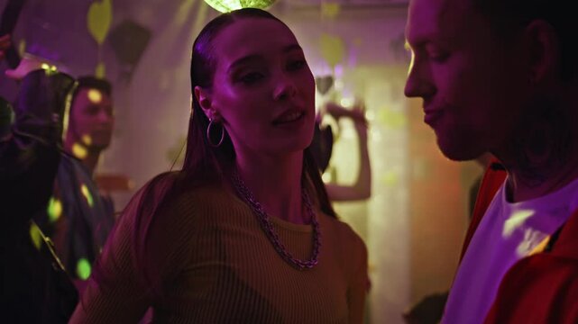 Dancing woman looking boyfriend with magnetic gaze at party atmosphere closeup