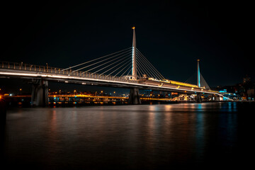 Obraz premium Istanbul, View of Illuminated Golden Horn Metro Bridge Over the Sea with City View in the Dark.