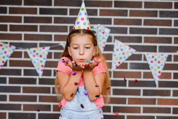 Cute preschooler girl makes art at a summer outdoor party