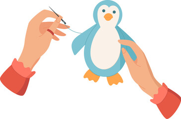 Fototapeta premium Hands sewing a cute penguin toy with needle and thread. DIY activity for children in craft workshop or class. Concept of creative hobbies, handmade art, and engaging activities for kids.