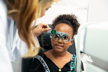 Eye impaired young girl patient getting eyesight checkup examined and treated by specialist eye...