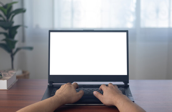 man's hands working on laptop in front of white