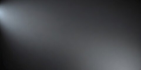 A dark grey background with a light shining on it