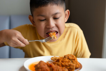 boy eating fried chicken.