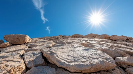 The sun high in the sky, casting intricate shadows over rocky terrain