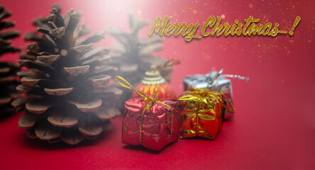 Festive pine cones and gift boxes on a red Christmas background