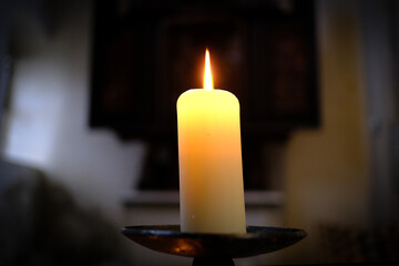 Prayer church candle in the church. Close up.