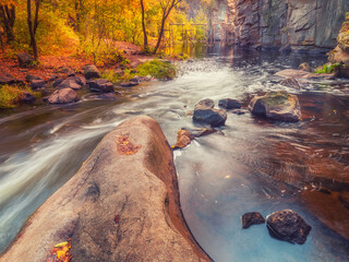 beautiful autumn day in canyon with river and stones in water with nobody 