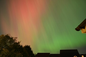 Aurora Borealis Over Rooftops