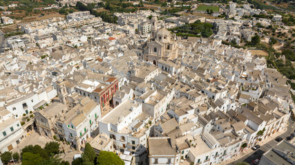 Aerial view of the historic center of Locorotondo, in the metropolitan city of Bari, Italy. In background is the church of San Giorgio Martire, the main church of the town.