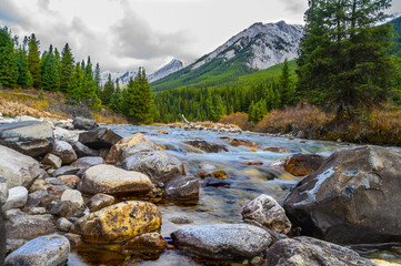 Inkpots ponds at Johnston Canyon river stream through rocks scenery with Mountains in background in Banff National Park Alberta, Mystic peak and Noetic Peak