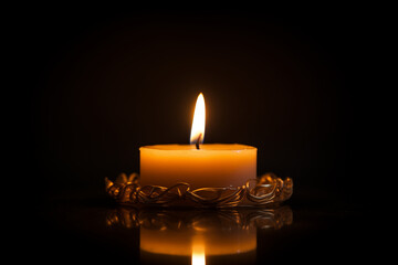 Single Burning Candle with Golden Holder on Black Background
