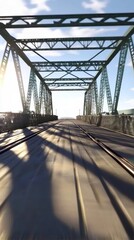 Obraz premium Train tracks crossing metal bridge on sunny day