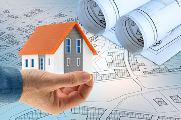Building activity and construction industry concept  with home model against an imaginary cadastral...