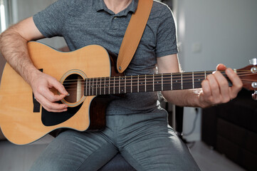 Naklejka premium Guitarist on acoustic guitar playing melody. Close up musician instrument