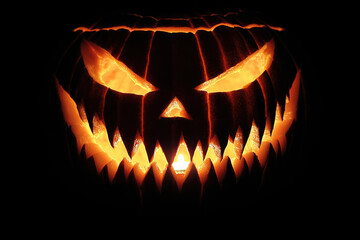 Fototapeta premium Halloween Pumpkin with Creepy Candlelight Glow