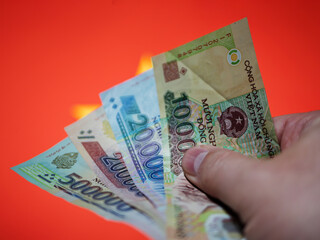 Vietnamese Currency Notes Held in a Hand