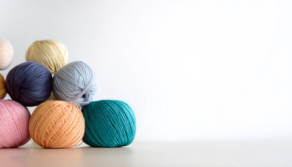 Colorful wool yarn balls on side position provides copy space for text. background concept isolated white