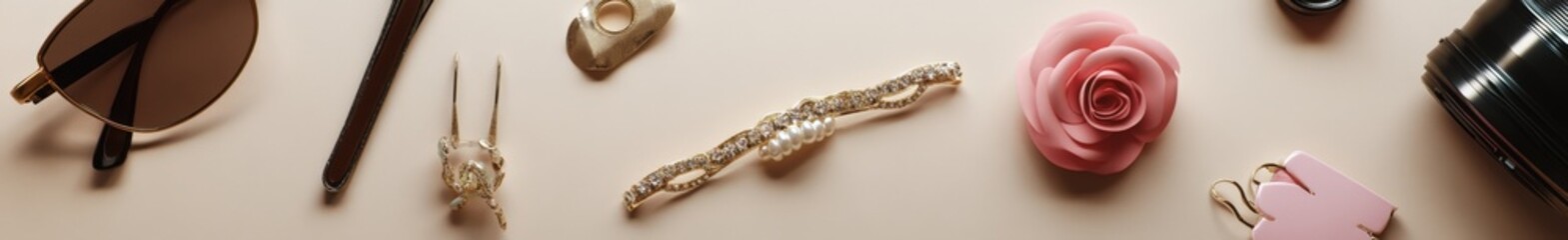 Assortment of fashionable accessories on a beige background