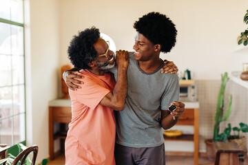 Cheerful father and son: Bonding and smiling together at home