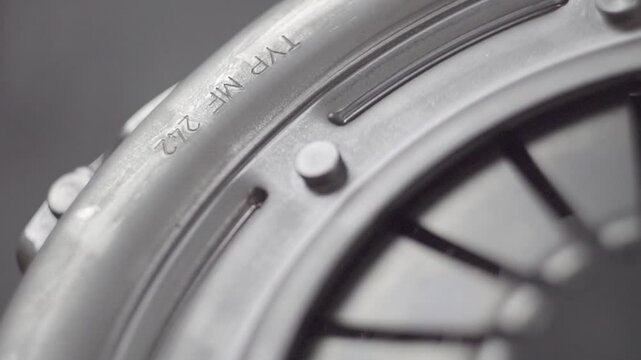 Clutch basket of automobile transmission. Pressure plane. Aluminum alloy. Shaft hole. Gearbox spare part. Manufacturing. Close-up. Slow motion