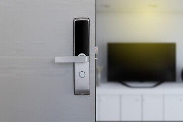 digital door handle on white door panel