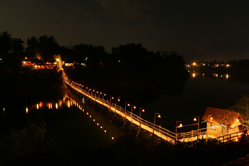 Fototapeta premium Night view, shot of the Bamboo Bridge over the Nam Khan River in Luang Prabang, Laos