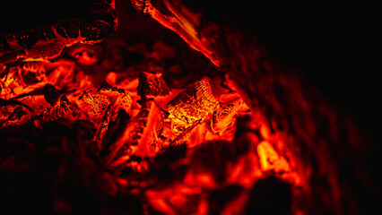 fire in the fireplace, burning wood, low key, selective focus, burning wood background 